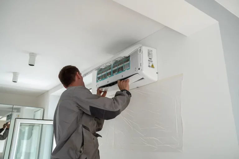 male-worker-installing-air-conditioner-in-apartmen
