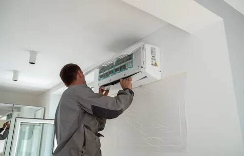 male-worker-installing-air-conditioner-in-apartmen