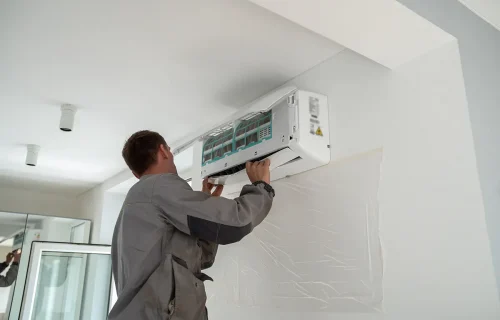 male-worker-installing-air-conditioner-in-apartmen